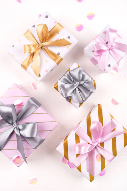 istock Set of gift boxes with bows and confetti on a white background. 1205813904