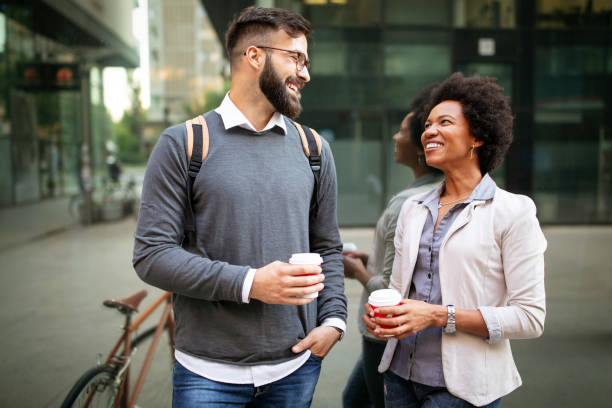 istock Business people discussing and smiling while walking together outdoor 1205814118