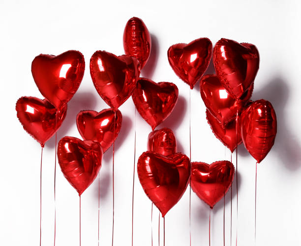 bunch of metallic red color heart shaped foil balloons on white background. set of air balloons valentines day - 4609 imagens e fotografias de stock