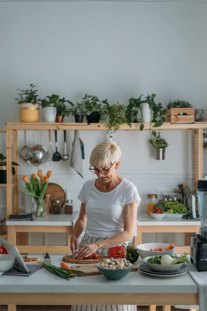 istock Woman Preparing Food at Kitchen 1205816739