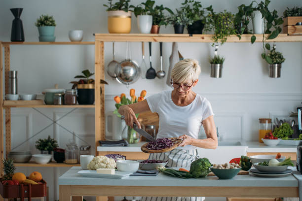 istock Woman Preparing Food at Kitchen 1205816762
