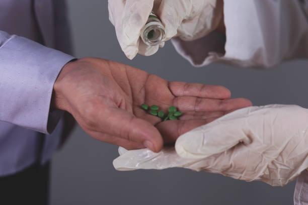 istock doctor and ill hand drug 1205816931