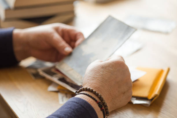 istock Memory. Eldery woman looking vintage photos. 1205817052