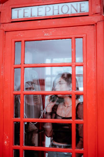 istock woman in red telephone box 1205818381