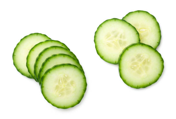 Cucumber Slice Isolated On White Background Cucumber slice isolated on white background. Light shadow. Top view, flat lay cucumber stock pictures, royalty-free photos & images