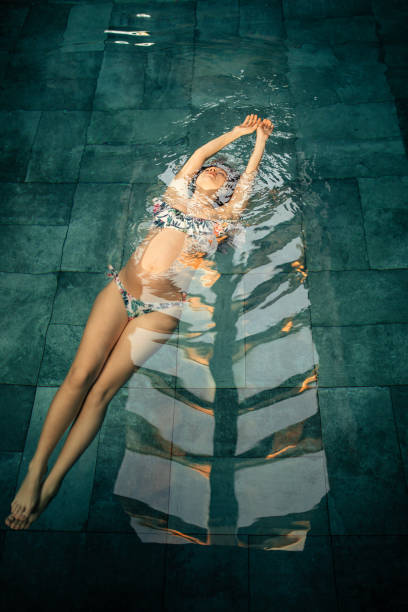 istock Beautiful young pregnant woman relaxing on poolside spa 1205820529