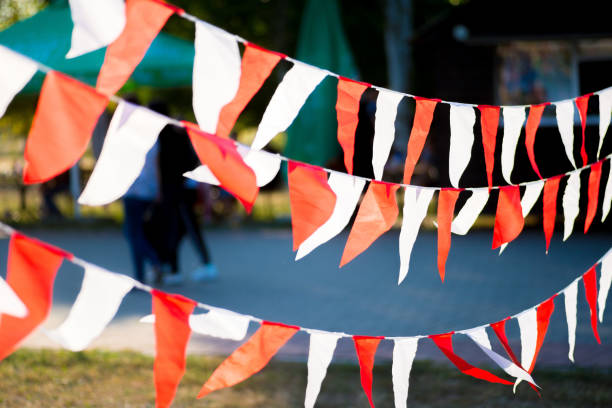 istock red and white garland flags hanging outdoors 1205821772