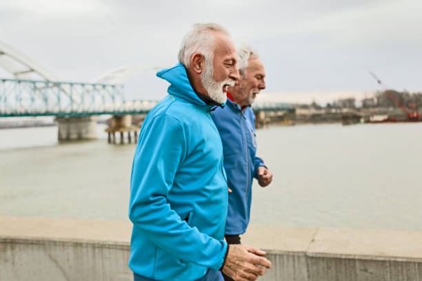 istock Senior man running together by a river 1205822059
