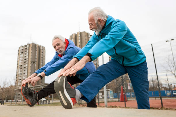 istock Senior sportsman stretching legs 1205822089