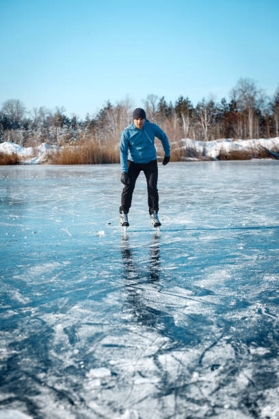 istock A young man skates on a frozen lake. 1205822840