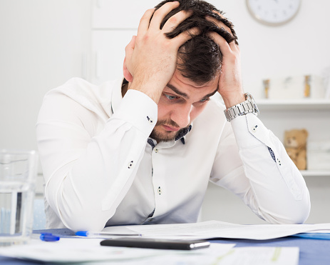 Young distressed man having no possibility to pay utility bills and rent