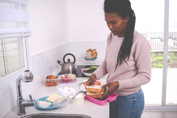 istock Woman packing a lunch box. 1205824800