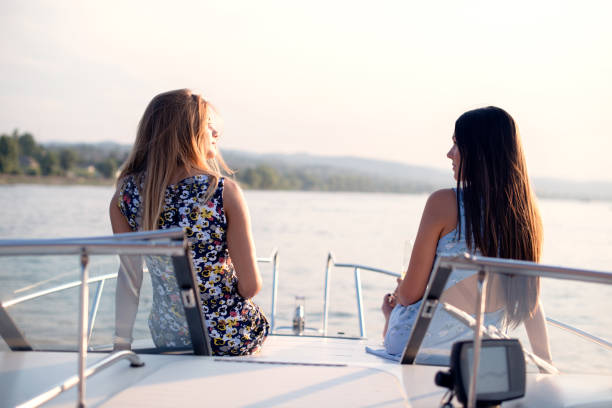 istock Two female friends enjoying on the boat 1205825717