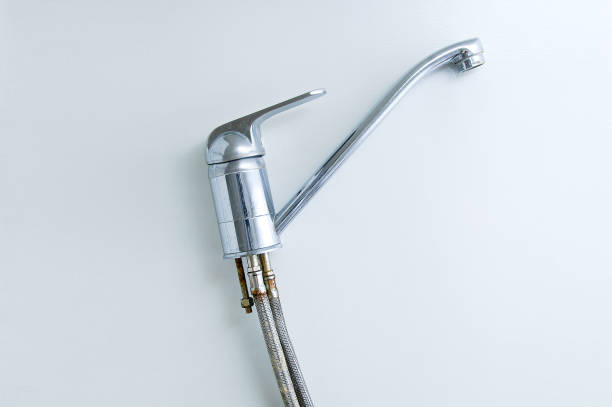 istock Old chromed water tap with rusty pipe close-up on a white background. 1205825900