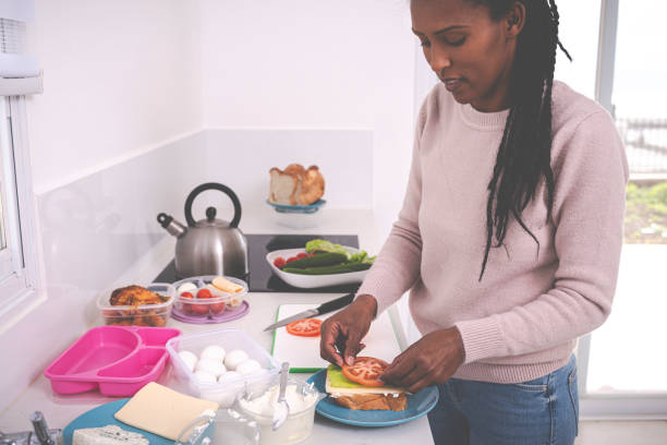 istock A woman making sandwich with tomato. 1205825993