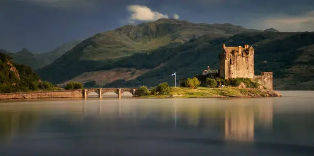 Panorama of Eilean Donan Castle with mountain in background, Scotland