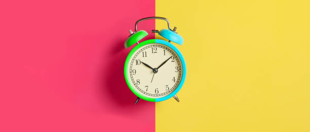 istock Trendy Multicolored alarm clock on bright colorful background. Top view. Flat lay 1205828692