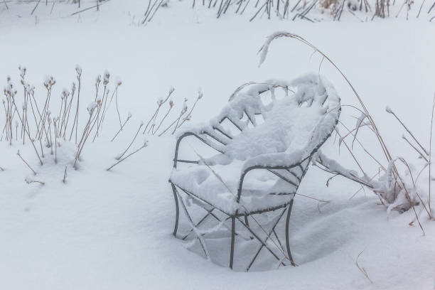 istock Wrought iron chair in the snow. 1205835639