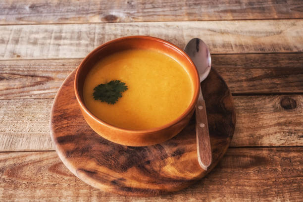 istock Pumpkin soup in bowl at table, close-up 1205836972