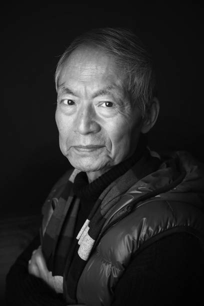 Portrait of an elderly man in \nblack and white.