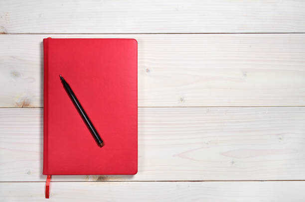 red notebook on a white wooden background - book photo album publication open imagens e fotografias de stock