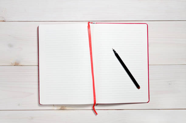 red notebook on a white wooden background - book photo album publication open imagens e fotografias de stock