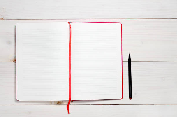 red notebook on a white wooden background - book photo album publication open imagens e fotografias de stock