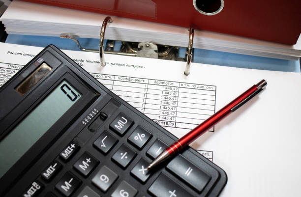 istock Stack of business report paper file on modern white desk table with calculator.business analysis and strategy concept 1205841789