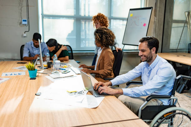 istock Disabled business executive in wheelchair 1205841954