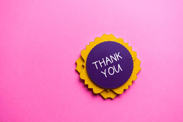 istock Thank You Concept. Purple and yellow note on pink background. 1205844564