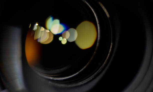istock Macro shot of a camera lens with colorful lights reflections 1205844765