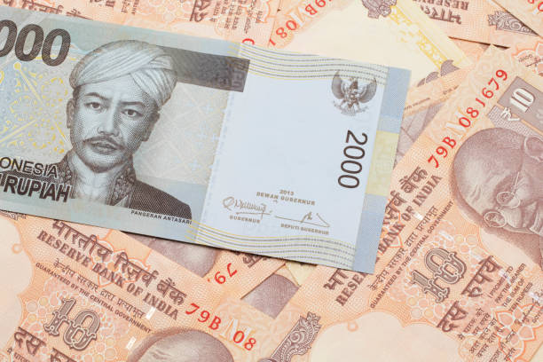 istock An Indonesian rupiah bank note with Indian ten rupee bank notes 1205846841