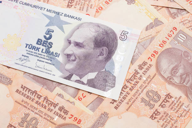 istock A five Turkish lira bank note on a background of Indian ten rupee bank notes 1205846844