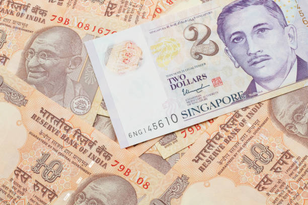 istock A two dollar bill from Singapore with Indian ten rupee bank notes 1205846859