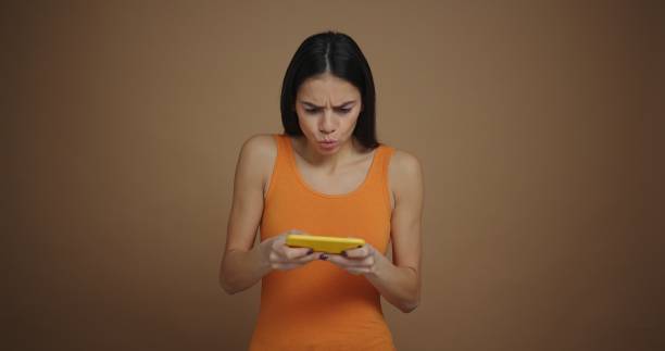 istock Focused beautiful woman playing a game on the smartphone while moving from side to side 1205848540