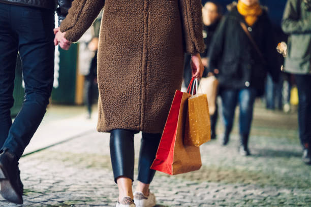 istock Couple holding hands while shopping for Christmas presents 1205848545