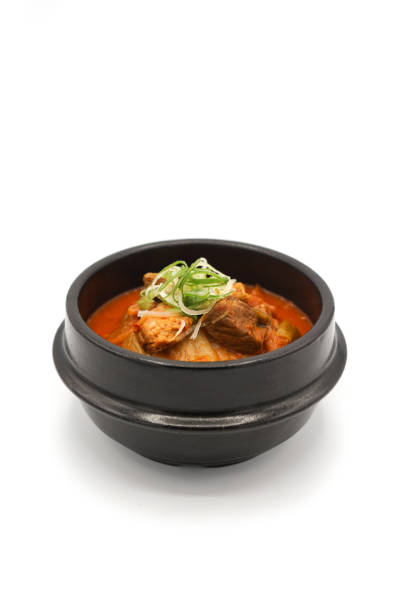 istock Isolated Kimchi soup in the black stone bowl in studio light on the white background. 1205848944