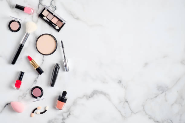 istock Professional makeup cosmetic products spilling out on to a marble table. Flat lay, view from above. Beauty blog banner design template 1205849646