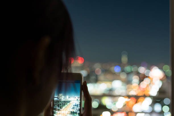 istock Tourist taking pictures with smart phone at night 1205851979