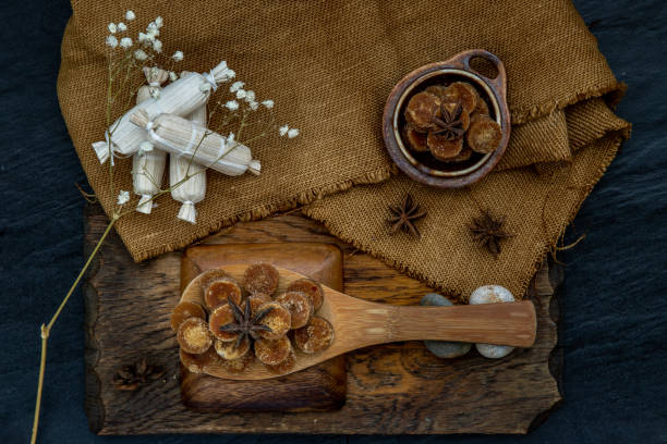 istock Brown cane sugar cube on wooden ladle and sackcloth. 1205853177