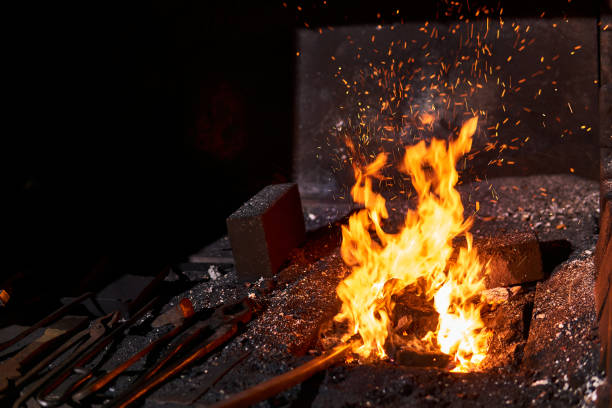 istock blacksmith furnace with burning fire and forging tools lying nearby 1205853389