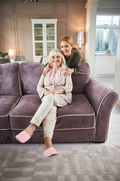 istock Happy senior lady resting on sofa at home 1205854161