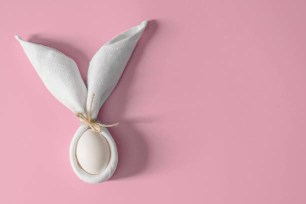 istock Easter table decoration with napkin in the form of rabbit ears and eggs. 1205854944