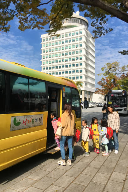 Kindergarten Picnic in Seoul Korea Seoul Korea - October 17th, 2019 : After fall picnic, kindergarten kids taking on the school bus at the Namsan Park in Seoul Korea . seoul bus stock pictures, royalty-free photos & images