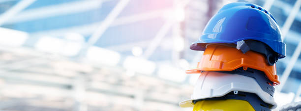 Safety Construction Worker Hats Blue, white, yellow, orange. Teamwork of construction team must have quality. Whether it engineer, construction workers. Have a helmet to wear at work. Safety at work. stock photo