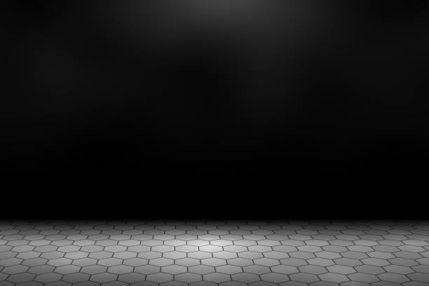 istock Spotlight shining down on gray concrete hexagonal paver blocks in dark road with copy space, abstract background 1205863716