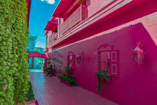 Pink street with green plants, windows, street lams, decorative caribbean entourage in old city victorian style, Puerto plata, Dominican Republic, Paseo de doña Blanca Pink street with green plants, windows, street lams, decorative caribbean entourage in old city victorian style, Puerto plata, Dominican Republic, Paseo de doña Blanca puerto plata stock pictures, royalty-free photos & images