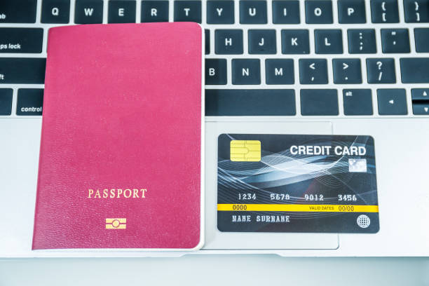 istock Credit card and passport on keyboard 1205871297