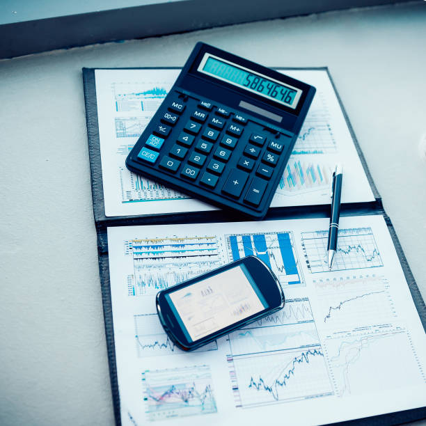 istock calculator, smartphone and financial documents on the businessman's Desk 1205871435