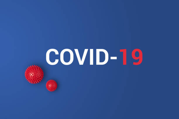istock Iinscription COVID-19 on blue background with red ball 1205872351